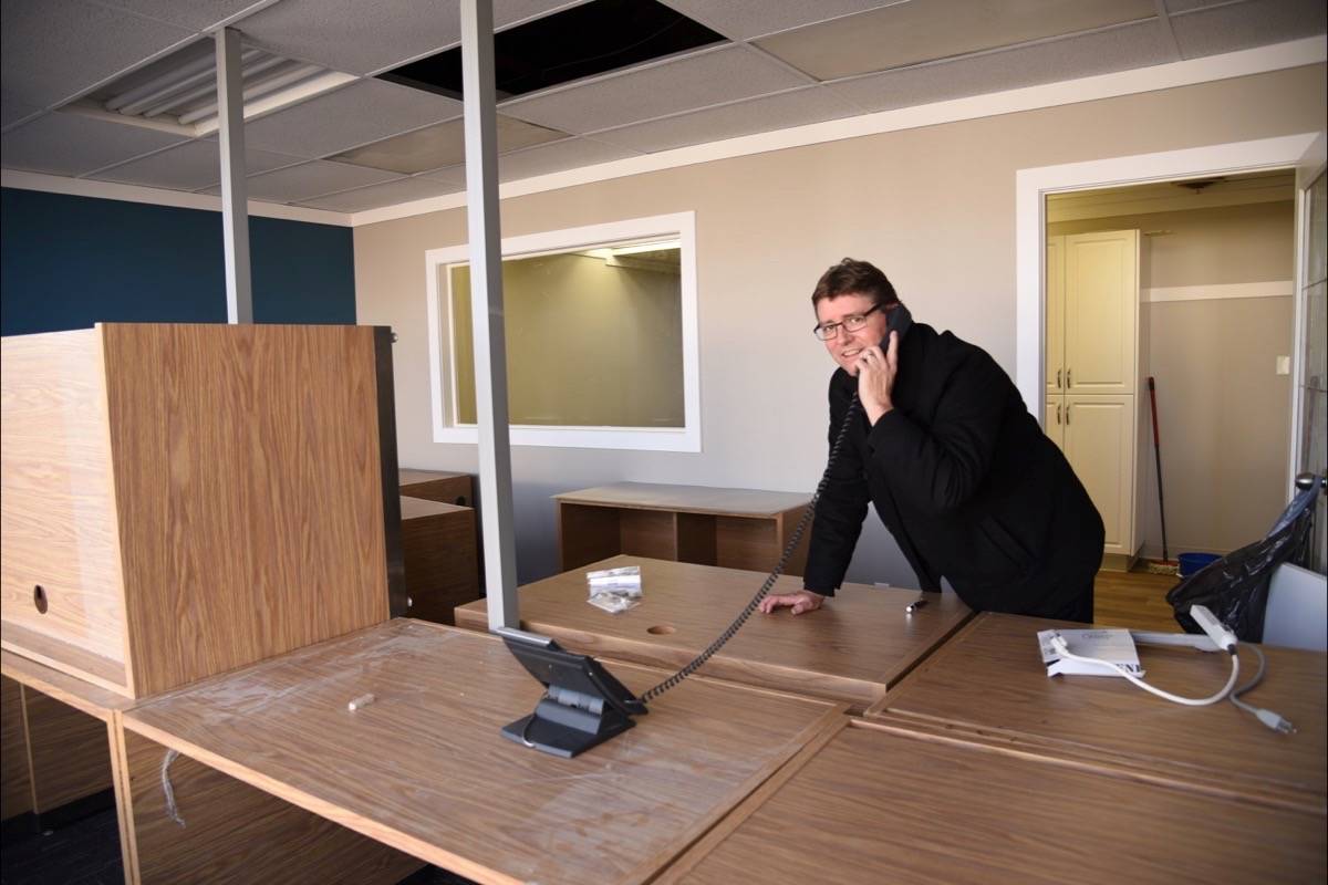 NEW DIGS - Mark Jones, CEO of the Central Alberta Child Advocacy Centre, poses in the organization’s new location in the Bunn Building downtown. Michelle Falk/Red Deer Express                                TAKING A CALL - CEO of the Child Advocacy Centre Mark Jones, in the new office space, which opened Dec. 1st.Michelle Falk/Red Deer Express