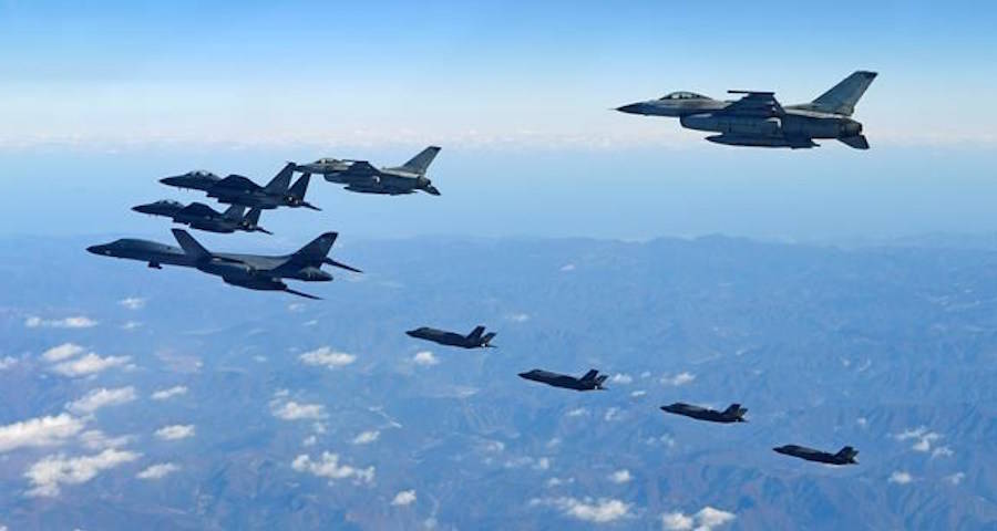 In this photo provided by South Korea Defense Ministry, U.S. Air Force B-1B bomber, far left, South Korea and U.S. fighter jets fly over the Korean Peninsula during the combined aerial exercise, South Korea, Wednesday, Dec. 6, 2017. (South Korea Defense Ministry via AP)