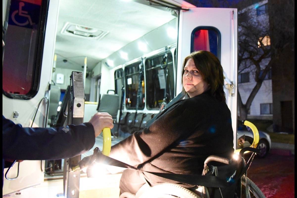 ACTION BUS - Heather Dahl, an advocate for accessibility in Red Deer, gets onto the Action Bus the morning of Dec 5th to go to work. Michelle Falk/Red Deer Express