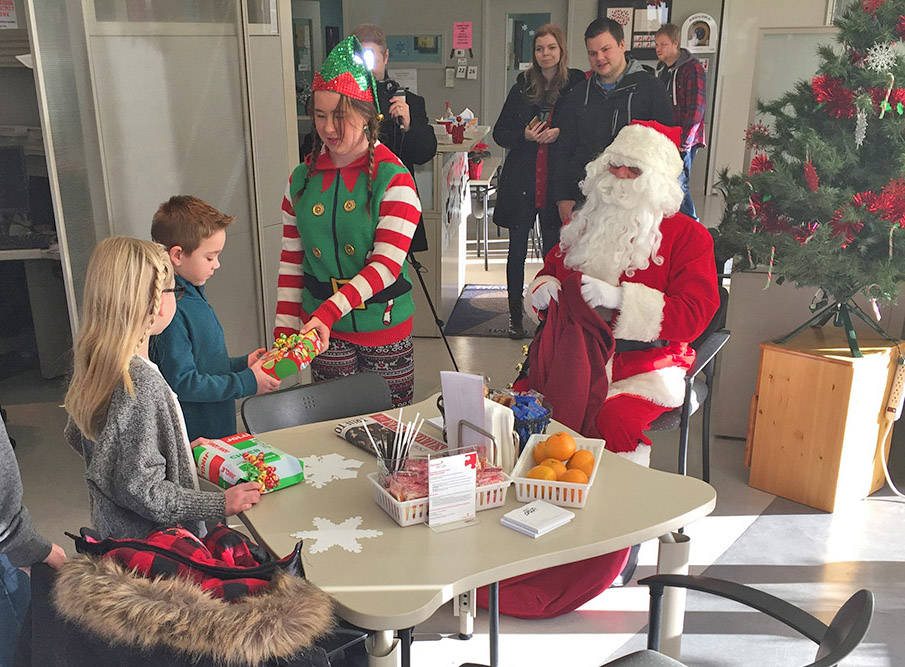 SANTA VISITS - Santa and his elf paid a visit to Red Deer’s Canadian Blood Services clinic Dec. 8th to give blood and meet the Berry Family. photo submitted