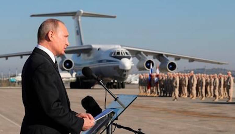 Russian President Vladimir Putin addresses to the troops at the Hemeimeem air base in Syria, on Monday, Dec. 11, 2017. (Mikhail Klimentyev, Sputnik, Kremlin Pool Photo via AP)