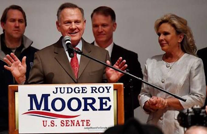 U.S. Senate candidate Roy Moore speaks as his wife U.S. Senate candidate Roy Moore and Kayla Moore look son at the end of an election-night watch party at the RSA activity center, Tuesday, Dec. 12, 2017, in Montgomery, Ala. (AP Photo/Mike Stewart)