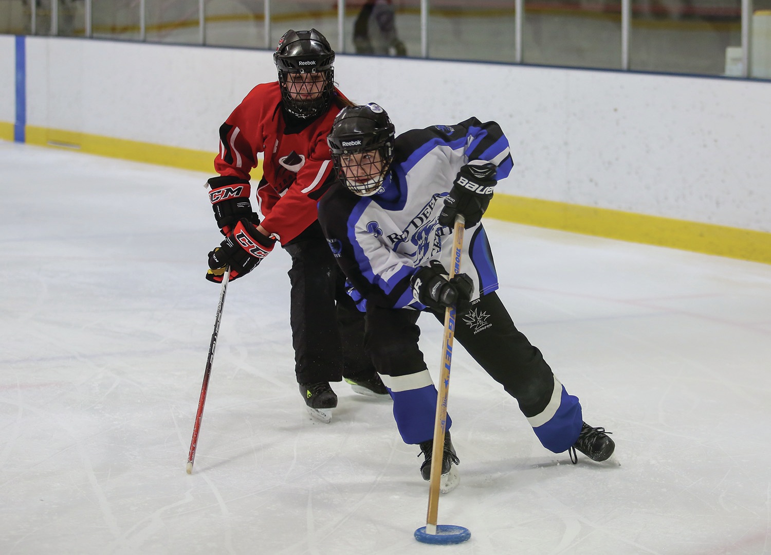 RINGETTE RIOT - From right, Alex Makortoff of the U14A Red Deer Riot skated past Emily Moch of the Strathmore Fire & Ice during round robin play at the 33rd annual Red Deer Friends on Ice tournament at the Kinsmen Community Arenas last year.Red Deer Express File Photo