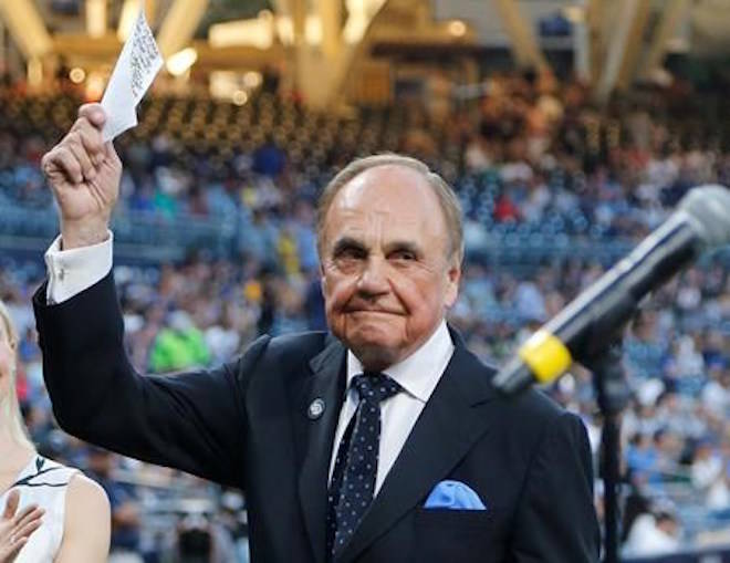FILE - In this Sept. 29, 2016, file photo, San Diego Padres broadcaster Dick Enberg waves to crowd at a retirement ceremony prior to the Padres’ final home baseball game of the season, against the Los Angeles Dodgers in San Diego. (AP Photo/Lenny Ignelzi, File)