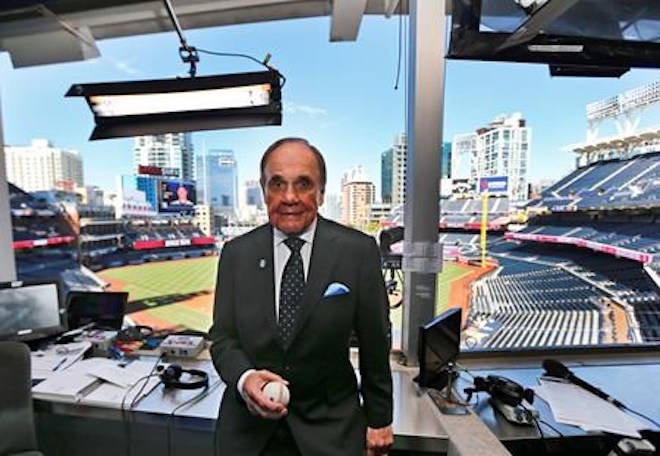 FILE - In this Sept. 29, 2016, file photo, Dick Enberg, the voice of the San Diego Padres, poses in his booth prior to the Padres’ final home baseball game of the season in San Diego. (AP Photo/Lenny Ignelzi, File)