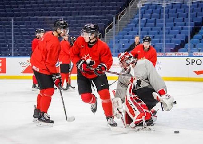 Canada’s Sam Steel, centre, skates with goalie Carter Hart, right, and Jordan Kyrou, left, during team practice at the IIHF World Junior Hockey Championship in Buffalo, N.Y., Monday, January 1, 2018. THE CANADIAN PRESS/Mark Blinch