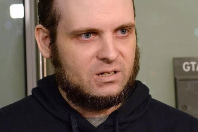 A lawyer for a Canadian man recently freed with his wife and children after years of being held hostage in Afghanistan says his client has been arrested and faces at least a dozen charges. Joshua Boyle speaks to members of the media at Toronto’s Pearson International Airport on Friday, October 13, 2017. THE CANADIAN PRESS/Nathan Denette