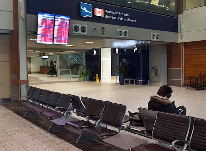 An arrivals and departures information screen is seen at the Halifax Stanfield International Airport in Halifax on Thursday, Jan. 4, 2018. Environment Canada has issued winter storm warnings and watches for Nova Scotia, New Brunswick, P.E.I. and parts of Newfoundland and Labrador, saying the low-pressure system east of Cape Hatteras will bring fierce winds and heavy snow. THE CANADIAN PRESS/Andrew Vaughan