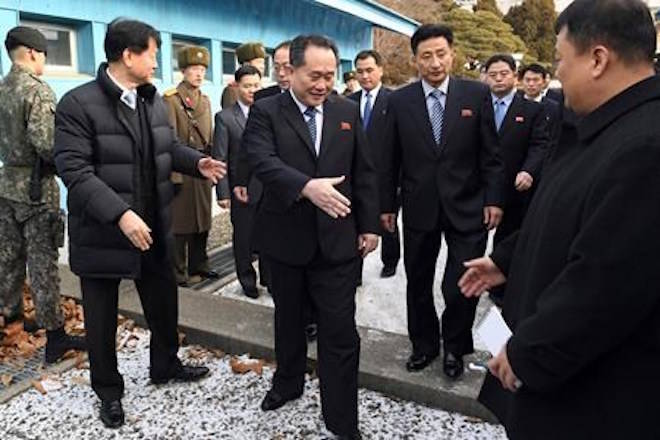 The head of North Korean delegation Ri Son Gwon, center, is greeted by South Korean officials after he crosses the border line to attend their meeting at Panmunjom in the Demilitarized Zone in Paju, South Korea, Tuesday, Jan. 9, 2018. North Korea agreed Tuesday to send a delegation to next month’s Winter Olympics in South Korea, Seoul officials said, as the bitter rivals sat for rare talks at the border to discuss how to cooperate in the Olympics and improve their long-strained ties. (Korea Pool via AP)