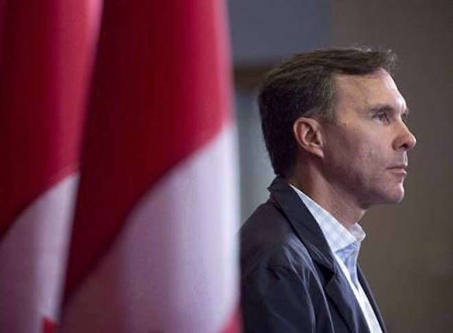 Finance Minister Bill Morneau takes questions as the Liberal cabinet meets in St. John’s, N.L. on Tuesday, Sept. 12, 2017. The federal ethics commissioner has cleared Finance Minister Bill Morneau of insinuations that both he and his father benefited from insider information to save half a million dollars on the sale of shares in the family-built company. THE CANADIAN PRESS/Andrew Vaughan