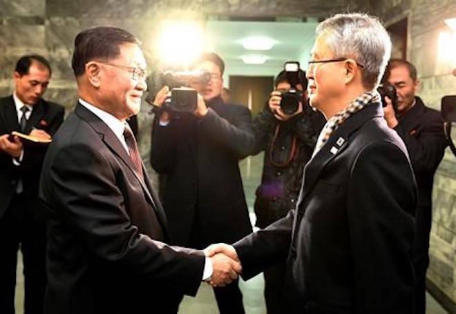In this photo provided by South Korea Unification Ministry, the head of South Korean delegation Lee Woo-sung, right, shakes hands with the head of North Korean delegation Kwon Hook Bong, left, before their meeting at the North side of Panmunjom in North Korea, Monday, Jan. 15, 2018. Officials from the Koreas met Monday to work out details about North Korea’s plan to send an art troupe to the South during next month’s Winter Olympics, as the rivals tried to follow up on the North’s recent agreement to cooperate in the Games in a conciliatory gesture following months of nuclear tensions. (South Korea Unification Ministry via AP)