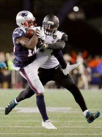 New England Patriots wide receiver Phillip Dorsett (13) makes a catch against Jacksonville Jaguars linebacker Myles Jack (44) during the second half of the AFC championship NFL football game on Sunday in Foxborough, Mass. (AP Photo/David J. Phillip)