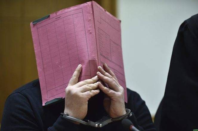This Jan. 22, 2015 file photo shows former nurse Niels Hoegel covering his face during his trial at the regional court in in Oldenburg, northern Germany. Carmen Jaspersen/dpa via AP