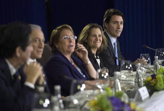 Prime Minister Justin Trudeau, right, sits beside Minister of International Trade Chrystia Freehand as they take part in a Trans-Pacific Partnership meeting on the side-lines of the APEC Summit in Manila, Philippines on Wednesday, November 18, 2015. Canada and the remaining members of the Trans-Pacific Partnership have agreed to a revised trade agreement, according to several international media reports early Tuesday.Sean Kilpatrick / THE CANADIAN PRESS