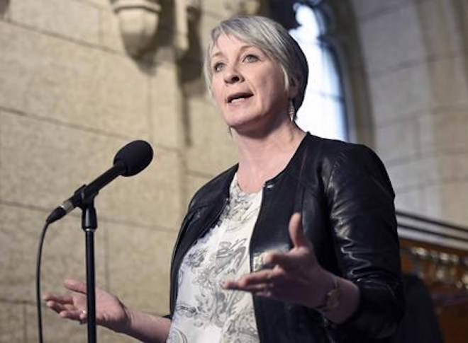 Minister of Employment, Workforce Development and Labour Patty Hajdu speaks to reporters during a weekend meeting of the national caucus on Parliament Hill in Ottawa on Saturday, March 25, 2017. The Liberal government has clarified what it would mean for organizations seeking youth summer job funding to prove they respect reproductive and other rights, but is standing firm on its decision to deny grants to groups advocating against abortion. THE CANADIAN PRESS/Justin Tang