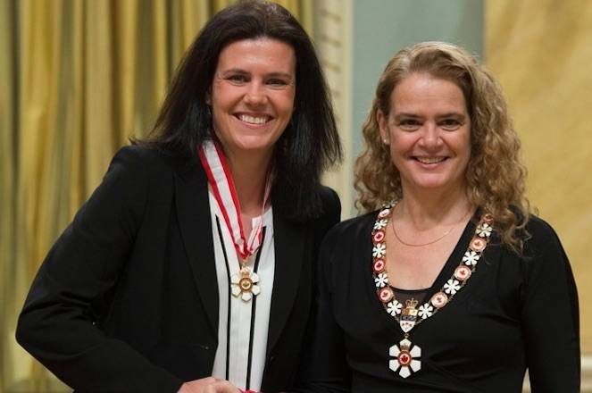 Canadian soccer great Christine Sinclair, left, was invested as an officer of the Order of Canada by Governor General Julie Payette, right, on Wednesday in Ottawa. (Adrian Wyld/Canadian Press)