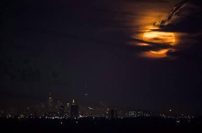 The full moon rises over the Toronto skyline as seen from Milton, Ont., on Monday, November 14, 2016. There will be a super blue blood moon on Wednesday and a total lunar eclipse, events that by themselves are not uncommon but combined they make for a spectacular night for skywatchers in Western Canada. On the West Coast, the skies will feature the fantastic lunar show as the gravitational forces of the sun and moon churn up the strongest tides of the year, known as king or spring tides. THE CANADIAN PRESS/Mark Blinch