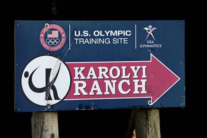 In this Sept, 12, 2015 photo, a sign points down the road to the Karolyi Ranch near New Waverly, Texas. Texas Gov. Greg Abbott on Tuesday, Jan. 30, 2018, has ordered a criminal investigation into claims that former doctor Larry Nassar abused some of his victims at the Texas ranch that was the training ground for U.S. women’s gymnastics .(AP Photo/David J. Phillip, File)