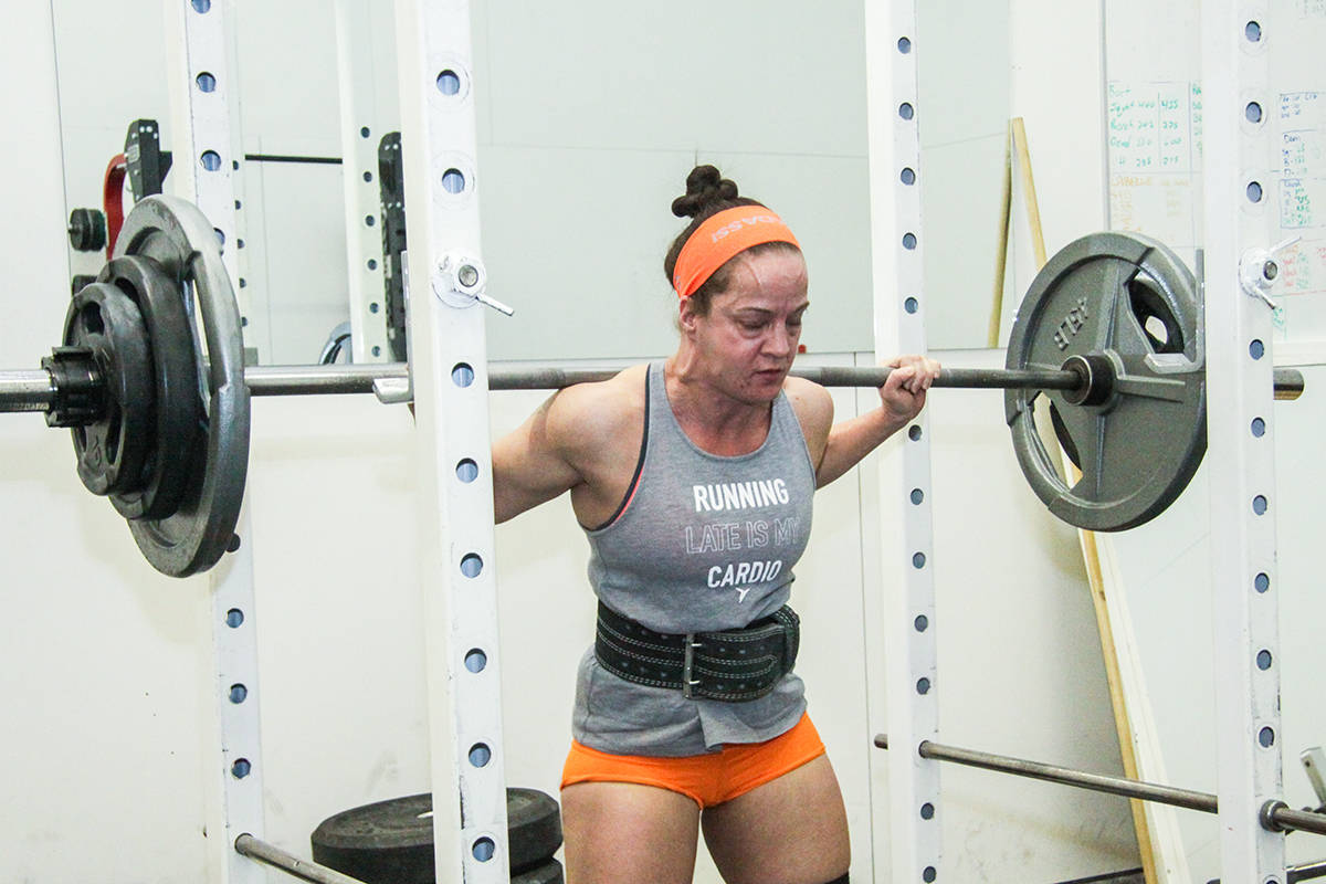 POWER LIFTER - Kerri Skladan demonstrated a squat at Body Basics. The squat, along with dead lifts and bench presses make up the sport of power lifting. Todd Colin Vaughan/Red Deer Express