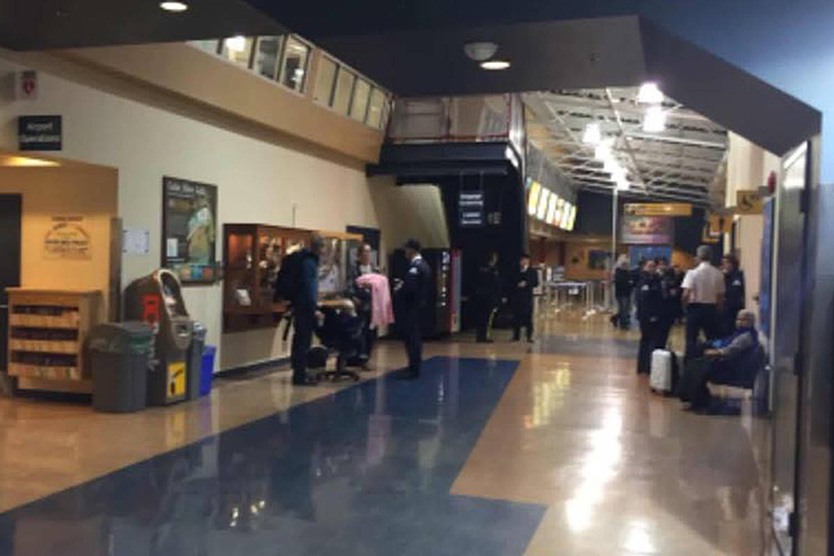 Travellers were left to mull around in the Comox Airport lobby Friday morning, after being removed from Flight 8306 to Vancouver. A suspicious package was found aboard the plane. Photo by Debbie Bowman.