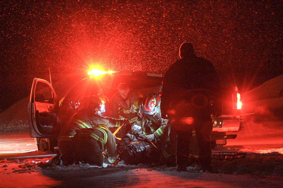 Members of the Ponoka County East District Fire Department were called to the scene of a skidoo accident Saturday night north of Ponoka. Here firefighters prepare the skidoo driver involved to be put on a spinal board. It is unclear the extent of the injuries from the incident. Photo by Jeffrey Heyden-Kaye