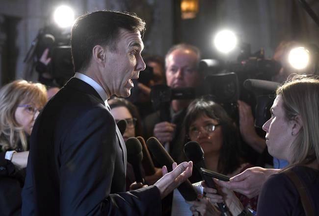 Minister of Finance Bill Morneau speaks to reporters after leaving a cabinet meeting on Parliament Hill in Ottawa on Feb. 6. (Justin Tang/The Canadian Press)