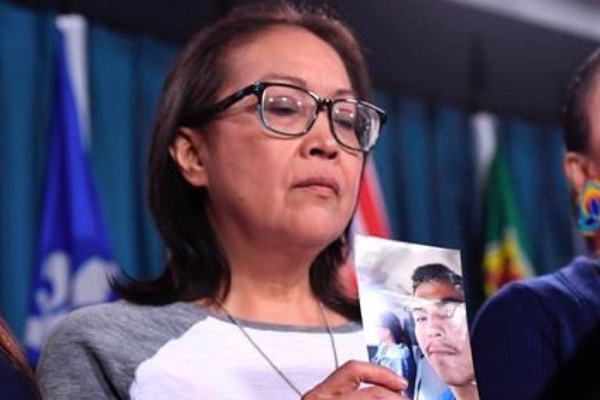 Debbie Baptiste, mother of Colten Boushie, holds a photo of her son during a news conference on Parliament Hill in Ottawa on Wednesday. (Justin Tang/The Canadian Press)