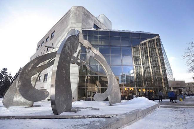 People enter the Law Courts in Winnipeg for the second degree murder trial of Raymond Cormier on Monday, February 5, 2018. THE CANADIAN PRESS/John Woods