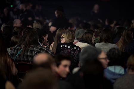 A fan wearing a t-shirt for the rock group Hedley sits in the crowd before the band’s concert in Halifax on Friday. (Darren Calabrese/The Canadian Press)
