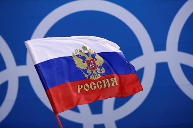 A Russian supporter waves a flag before the preliminary round of the men’s hockey game between the team from Russia and the United States at the 2018 Winter Olympics in Gangneung, South Korea, Saturday, Feb. 17, 2018. (AP Photo/Matt Slocum)                                A Russian supporter waves a flag before the preliminary round of the men’s hockey game between the team from Russia and the United States at the 2018 Winter Olympics in Gangneung, South Korea, Saturday, Feb. 17, 2018. (AP Photo/Matt Slocum)