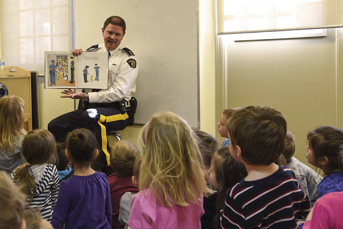 STORY TIME - Insp. Grobmeier read a story to pre-schoolers at Red Deer Public Library Downtown Branch today in a new program offered by the library. Michelle Falk/Red Deer Express