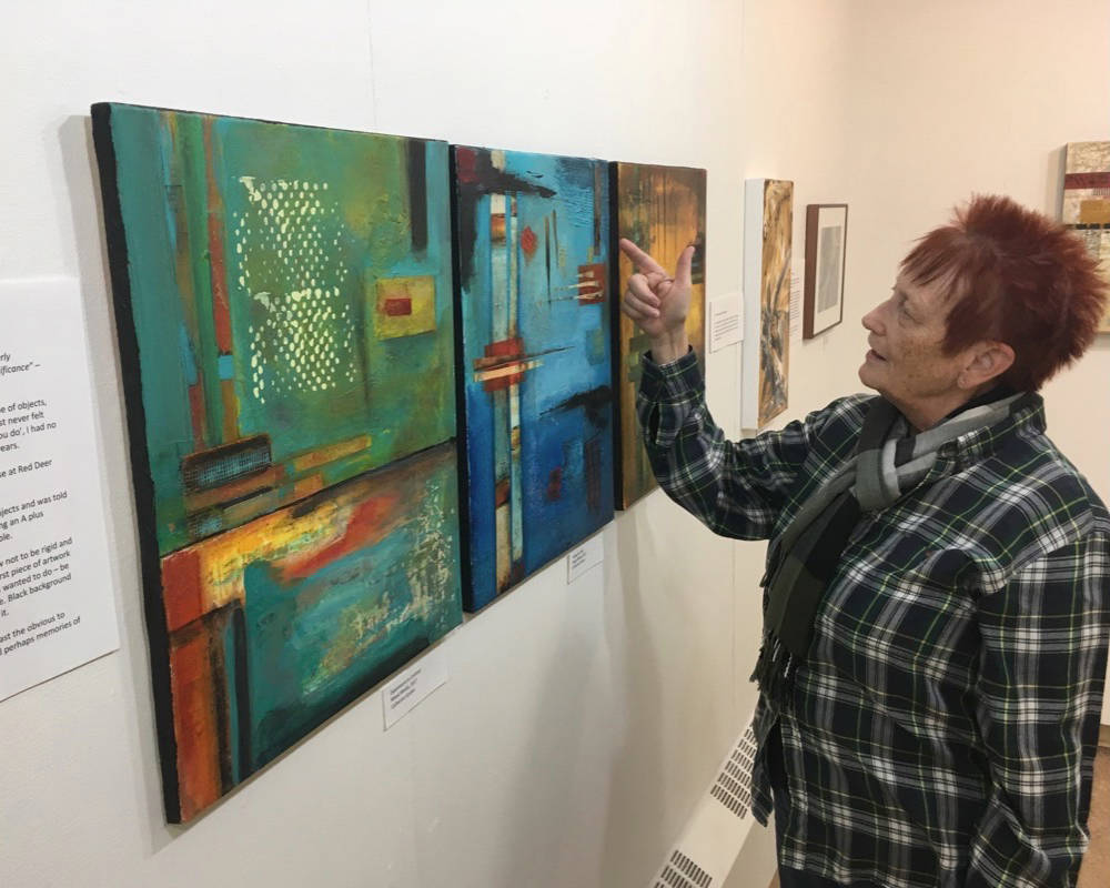 NEW SHOW - Diana Anderson of the Red Deer Arts Council discusses a work that’s featured in the Council’s current exhibit ‘My Kid Could Do That’ at the Red Deer Public Library downtown branch.                                Mark Weber/Red Deer Express