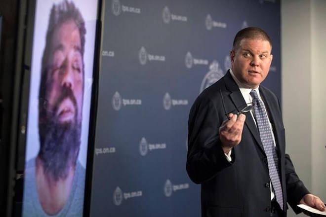 Det. Hank Idsinga, lead investigator in the case against alleged serial killer Bruce McArthur, stands with a photo of an unidentified man, suspected of being another of McArthur’s victims, during a news conference at Toronto Police headquarters on Monday, March 3 , 2018. THE CANADIAN PRESS/Chris Young