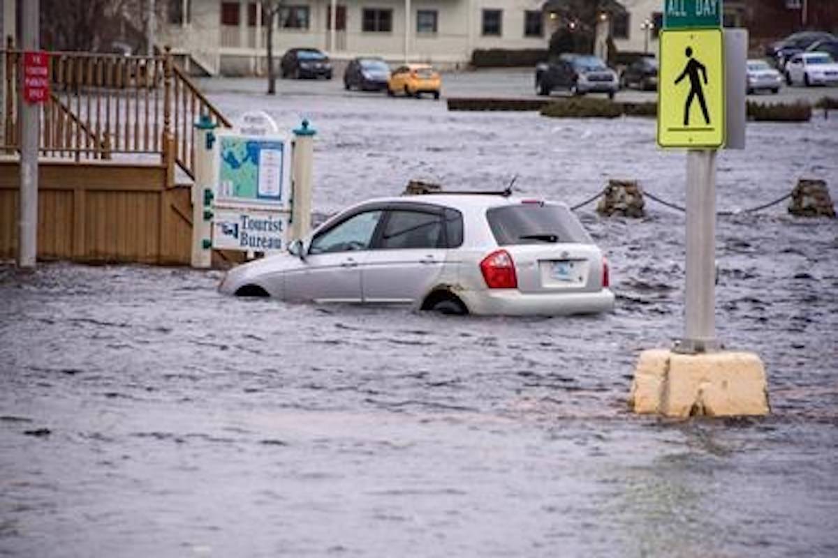 A car sits in sea water up to it’s wheel wells at a tourist bureau in Liverpool, Nova Scotia on Saturday March 3, 2018. After another weekend of storm surges battering Nova Scotia’s south shore, there’re rising concerns from some municipal politicians and citizens about the need for help adapting to climate change. THE CANADIAN PRESS/HO-Ken Veinot