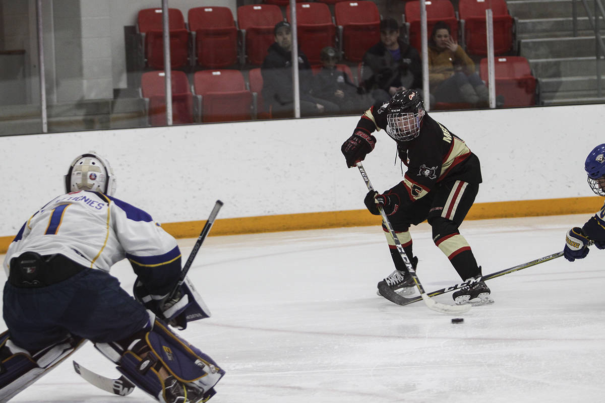 CHIEFS WIN - Red Deer AAA Optimist Chief Brett Meerman raced in against Calgary Royals’ netmider Noah Decottignies in their Game 3 matchup. The Chiefs would go on to win 2-1. Todd Colin Vaughan/Red Deer Express