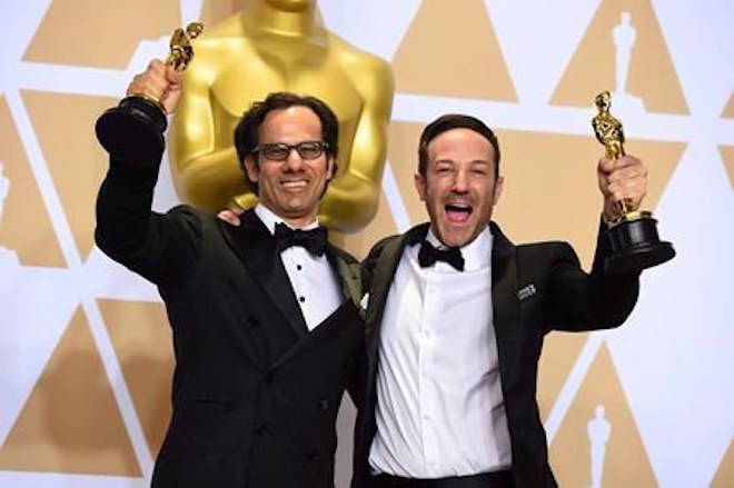 Dan Cogan, left, and Bryan Fogel, winners of the award for best documentary feature for “Icarus” pose in the press room at the Oscars on Sunday, March 4, 2018, at the Dolby Theatre in Los Angeles. An Oscar win for the doping documentary “Icarus” is “a great addition” to ongoing efforts to combat corruption in sport, says a Canadian investigator whose work helped severely limit Russia’s participation in the 2016 Olympic Games in Rio and the 2018 Winter Games in Pyeongchang. THE CANADIAN PRESS/AP-Photo by Jordan Strauss/Invision/AP