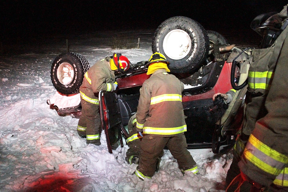 Members of the Ponoka County East District Fire Department investigate a Jeep that rolled Friday night east of Ponoka on Highway 53. At the time of the rollover there were icy patches along area highways. It’s believed there were little to no injuries from the incident.                                Photo by Jeffrey Heyden-Kaye