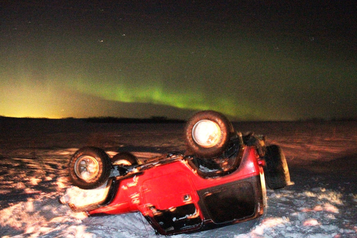 The northern lights contrast with this scene of a Jeep that rolled Friday night. The incident occurred east of Ponoka on Highway 53 and at it is believed icy patches on the highway were a factor. There were little to no injuries from the incident.                                Photo by Jeffrey Heyden-Kaye