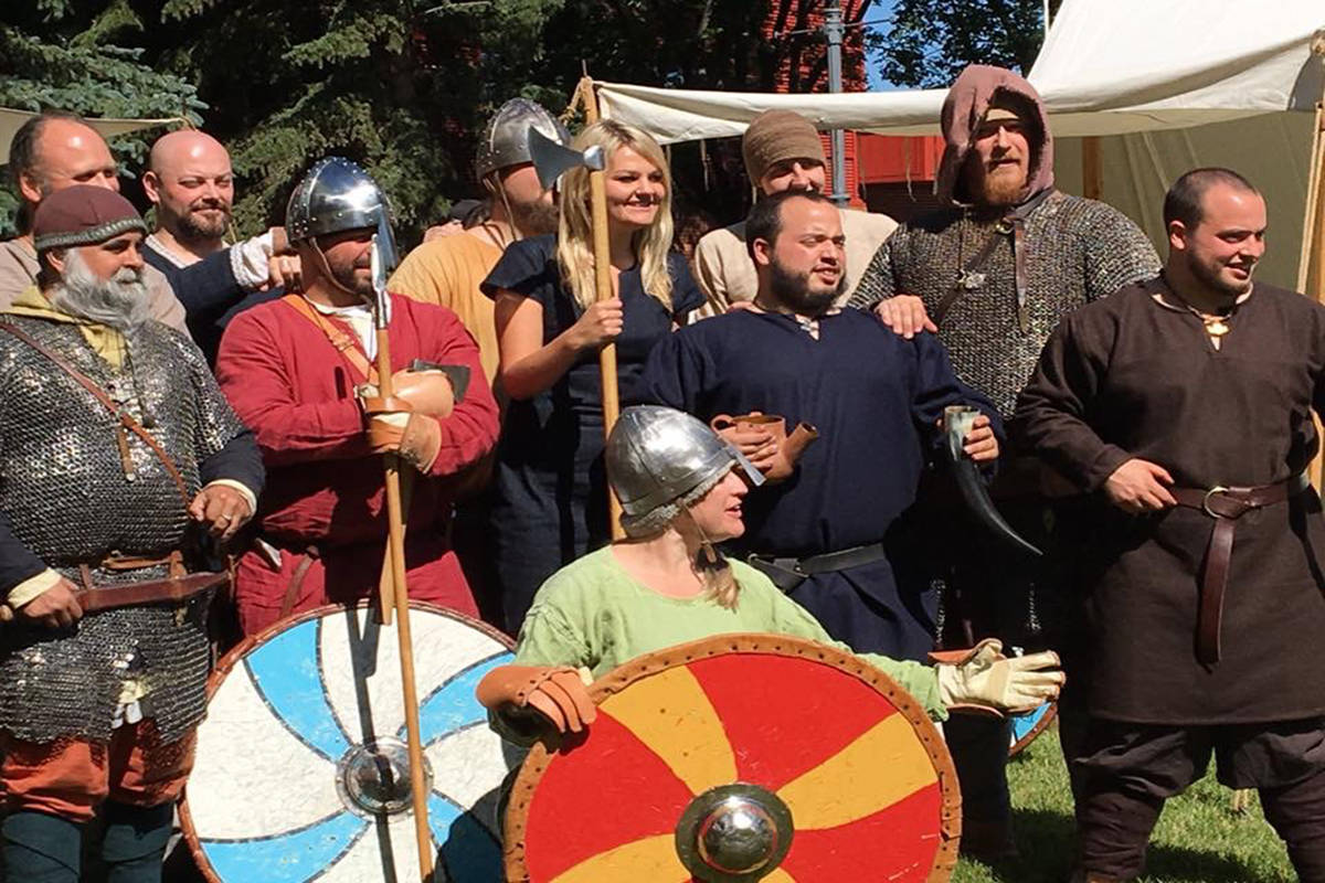 QUEEN OF VIKINGS - Mayor Tara Veer poses with historic reinactors at the Norwegian Laft Hus festival in Red Deer last summer. The event is an annual show that will take place again on June 30, 2018.                                Photo supplied by Heimdall’s Spears