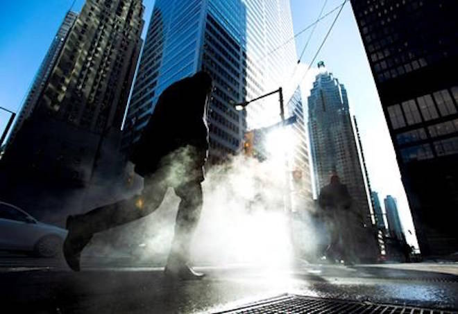 A man makes his way through the city’s financial district in downtown Toronto on January 28, 2014. The federal government committed hundreds of millions of dollars in its recent budget to help reinforce Canada’s cyber defences, but if the effort fails to prevent a major attack, Ottawa can always turn to its little-known $102-billion emergency stash. The rainy day fund of highly liquid assets is available to keep the government running for at least a month should the country ever find itself confronted by a severe crisis, such as a cyberattack that impairs access to financial markets. THE CANADIAN PRESS/Nathan Denette