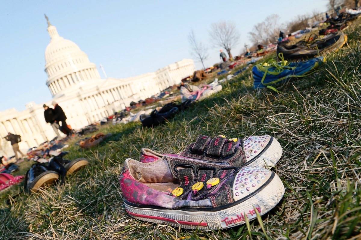 7,000 shoes filled the Capitol lawn on Tuesday to mark the number of children who have died as a result of gun violence since Sandy Hook. (Paul Morigi/AP Images for AVAAZ)
