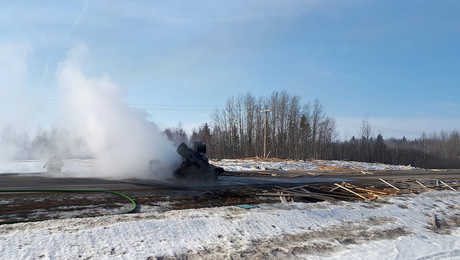 A semi tractor hauling lumber Wednesday morning near Breton rolled and caught on fire. The driver was uninjured but the incident has caused major delays on that stretch of road say RCMP.                                RCMP photo