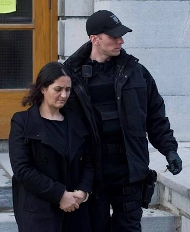 Tooba Yahya is led away from the Frontenac County courthouse in Kingston, Ont., Sunday, January 29, 2012, after being found guilty of first degree murder. A woman found guilty in 2012 of murdering her three daughters in a so-called mass honour killing has been stripped or her permanent residency and ordered deported from Canada.THE CANADIAN PRESS/Graham Hughes