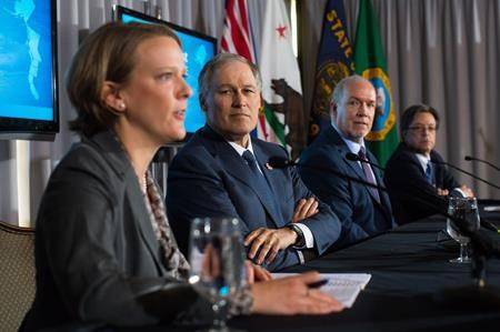 Oregon Energy Director Janine Benner, from left to right, Washington State Gov. Jay Inslee, B.C. Premier John Horgan and California Secretary for Environmental Protection Matt Rodriquez attend a news conference in Vancouver on Friday. (Darryl Dyck/The Canadian Press)