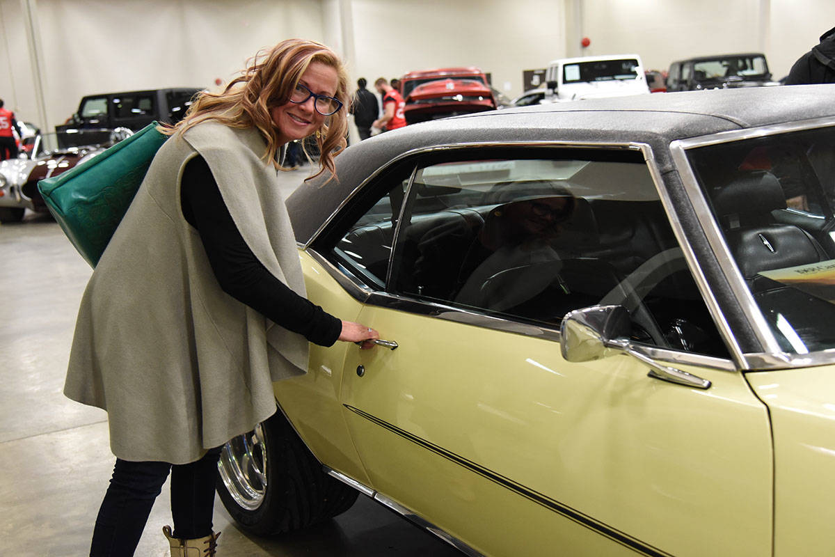 CAR LOVER - Jeanine Hanschah checks out a 1968 Chevrolet Camaro RS/SS 350 ZZ (Fast Burn 385) at the 12th annual Red Deer Collector Car Auction at Westerner Park March 16-18th. She travels from Edmonton for the auction every year.                                Michelle Falk/Red Deer Express