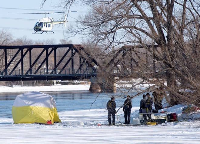 Police divers and a helicopter search the shores of the Riviere des Prairies on Montreal’s north shore, Monday, March 19, 2018 for missing 10-year old boy Ariel Jeffrey Kouakou who disappeared one week ago.THE CANADIAN PRESS/Ryan Remiorz