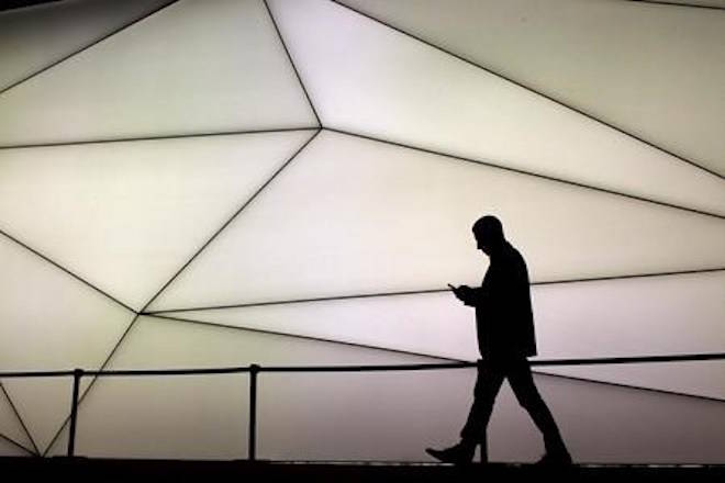 A man looks at his phone as he walks along the Samsung stand during the Mobile World Congress wireless show in Barcelona, Spain, on February 27, 2017. Canada’s wireless providers are preparing for a looming update to the National Public Alerting System that will force smartphones to sound an ominous alarm when an emergency alert is triggered. In a case of emergencies including Amber Alerts, forest fires, natural disasters, terrorist attacks or severe weather, officials will be able to send a localized alert that will compel compatible phones on an LTE network to emit an alarm — the same shrill beeping that accompanies TV and radio emergency alerts — and display a bilingual text warning. THE CANADIAN PRESS/AP, Emilio Morenatti