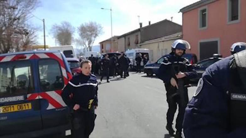 In this image taken from La Depeche Du Midi, police attend an incident in Trebes, southern France, Friday March 23, 2018. French counterterrorism prosecutors are taking charge of the investigation into the shooting of a police officer in southern France that has led to an apparent hostage-taking at a supermarket. (La Depeche Du Midi via AP)