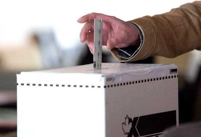 A man casts his vote for the federal election in a polling station on Toronto’s Ward Island on Monday, May 2, 2011. After more than two years riding the brakes on a raft of promised reforms to election laws, the Trudeau government is preparing to put the pedal to the metal to get them in place in time for the next federal election in 2019. THE CANADIAN PRESS/Chris Youn