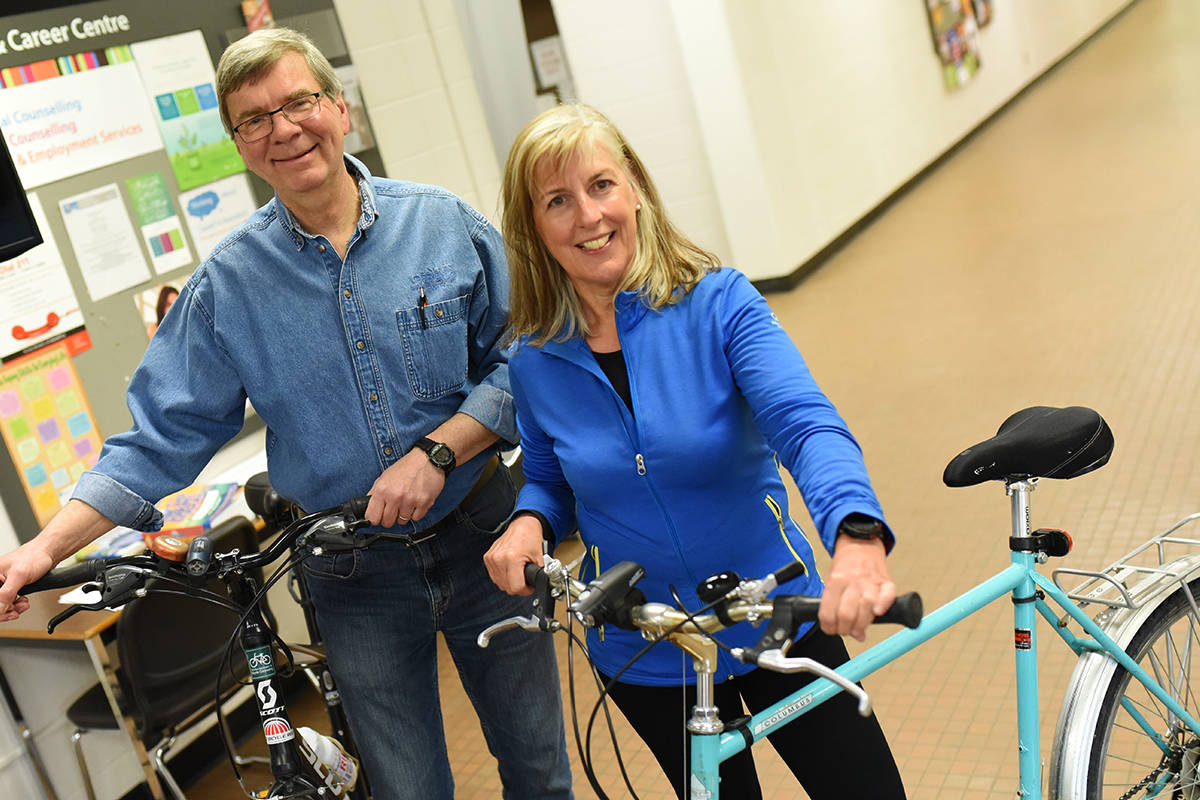 BICYCLE COMMUTERS - Bill Franz, president of the Red Deer Association for Bicycle Commuting and Liz Hagell, member and team lead of the organizing committee for Cyclovia Red Deer pose with their bikes at the Eco-Living Fair at RDC on March 24th. Michelle Falk/Red Deer Express